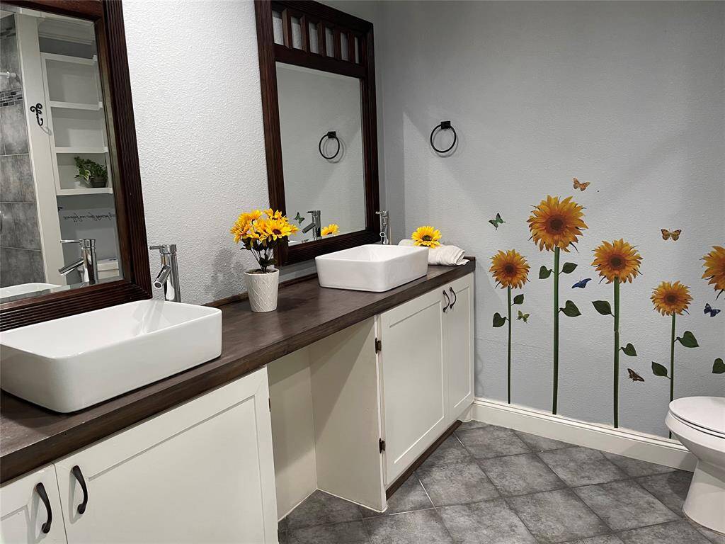 one bathroom in main house with double sink and tub