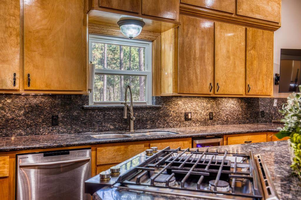 Gas Range on island and window overlooking the property while you do the dishes