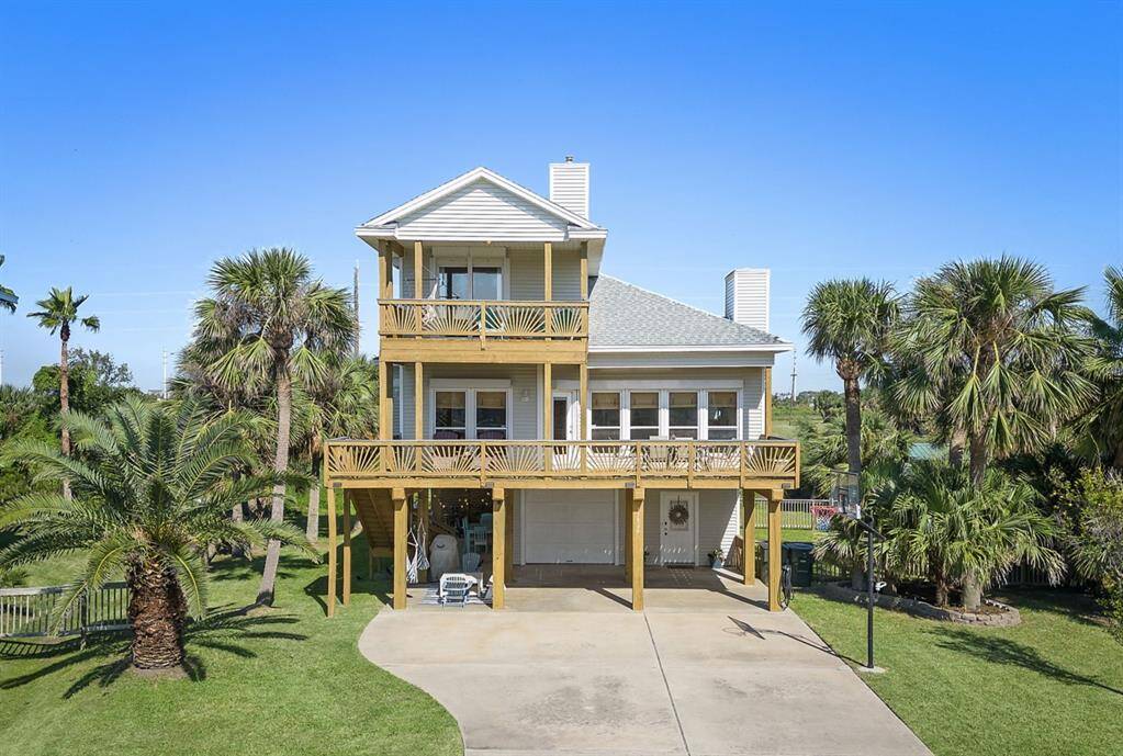 13826 Mutiny is a true beachside beauty, this elevated home offers a generous front deck and a spacious driveway. The mature palms and manicured lawn add to the tropical charm, while the raised design provides peace of mind and extra space below.