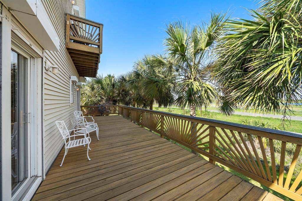 This spacious deck offers the perfect balance of shade and sunshine, surrounded by mature palms for a touch of coastal privacy. Whether sipping morning coffee or enjoying the evening breeze, this outdoor space is ideal for relaxing.