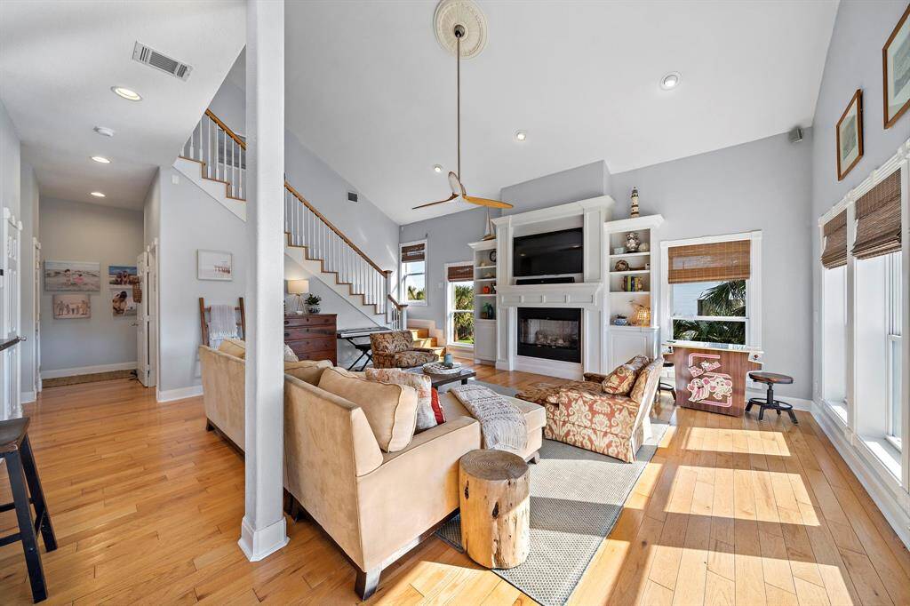 Featuring vaulted ceilings and a custom-built entertainment center with a gas fireplace, this cozy living area is the perfect place to unwind. The wide staircase adds architectural interest while leading to the upstairs retreat.