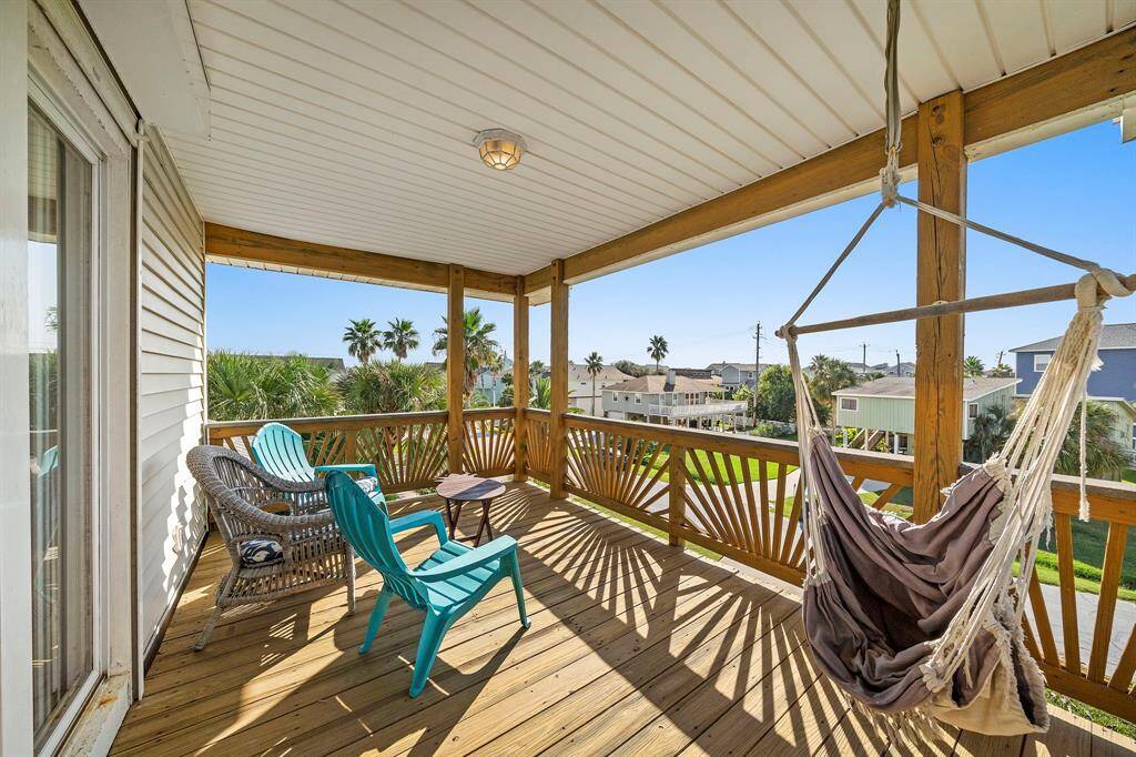 Charming and cozy, this private deck off the primary includes a fun hammock swing chair and relaxed seating area—ideal for lazy afternoons or evening chats under the stars.