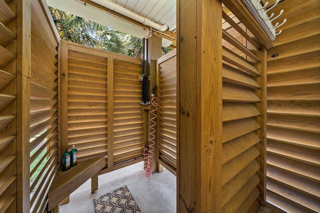 Rinse off the salt and sand in this private outdoor shower, tucked beneath the home and designed with wood slats for airflow and privacy. A beach day essential!