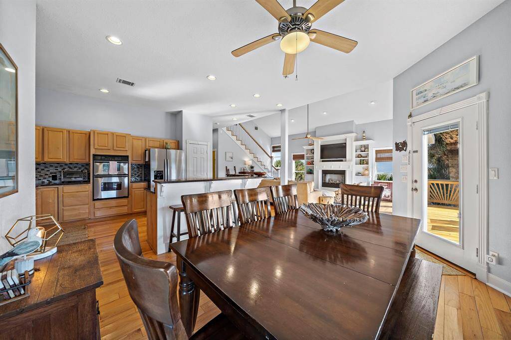 The dining room is the perfect gathering space, positioned between the kitchen and living area with seating for eight. Ample natural light and warm wood tones create an inviting atmosphere for meals and conversation.