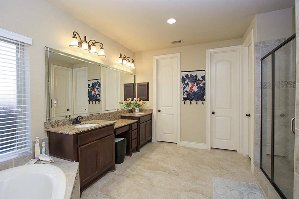 Huge master bathroom with his and hers closets and double sink.