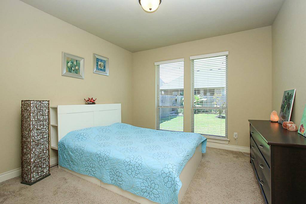 A secondary bedroom downstairs with in-suite full bath.