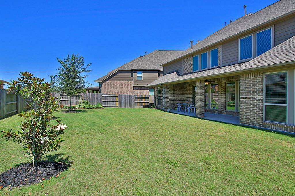 Large backyard with extended covered patio.