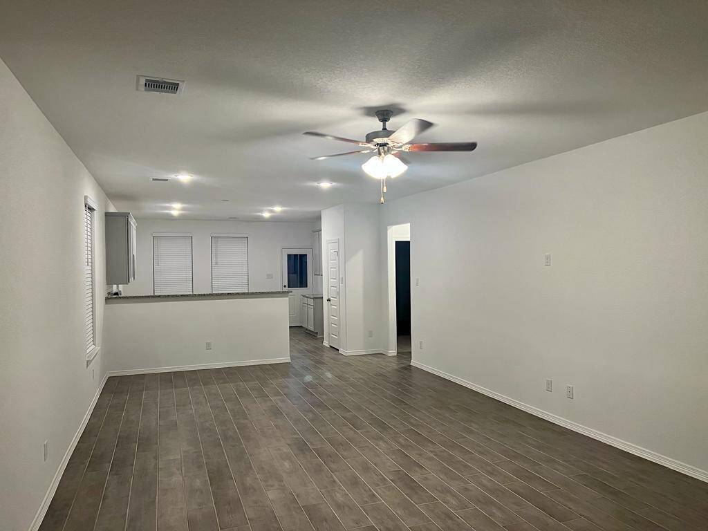 Beautiful Vinyl flooring show how the Kitchen opens up to the Living areas.