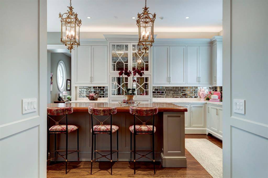 Wide cased opening with pocket doors and concealed pantries is a transition space between the kitchen and the China Room/Breakfast area.  Just a peak at this glamorous, yet functional kitchen with high end appliances and finishes.