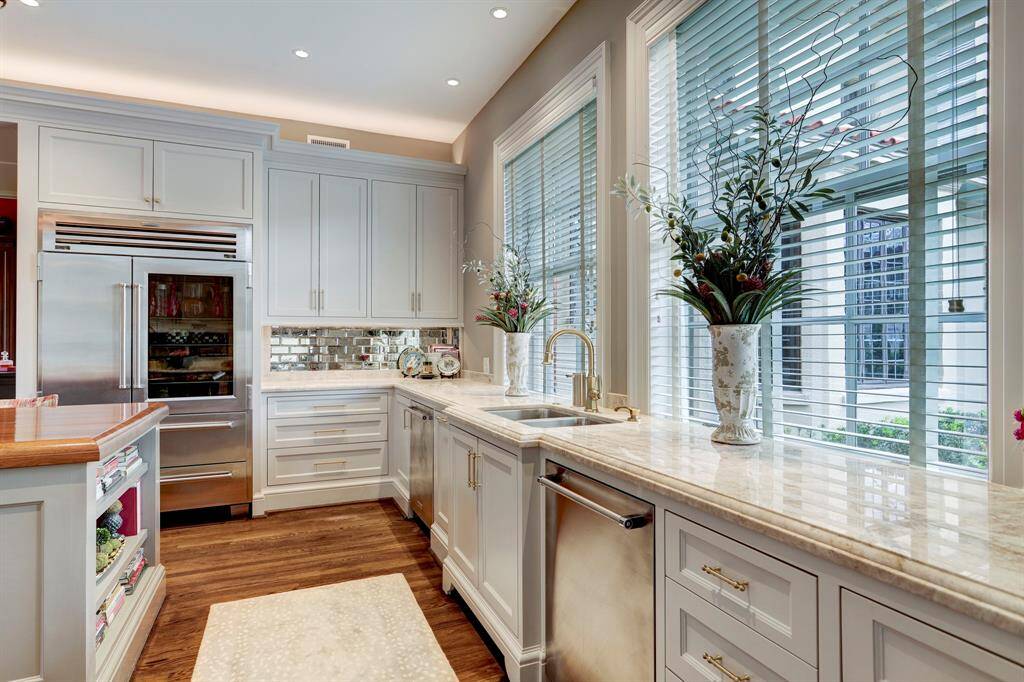 This perfectly appointed kitchen has two sinks , and the professional appliance package includes Wolf 6 burner range with 48" grill , gas stove, Sub Zero Pro 48 Refrigerator/Freezer, Wolf Warming drawer, steam oven and microwave and two Kitchenaide dishwashers.Plenty of cabinets and counter space and a sink with dish washer on each side.  A wall of windows that overlooks the side entrance and grill area.