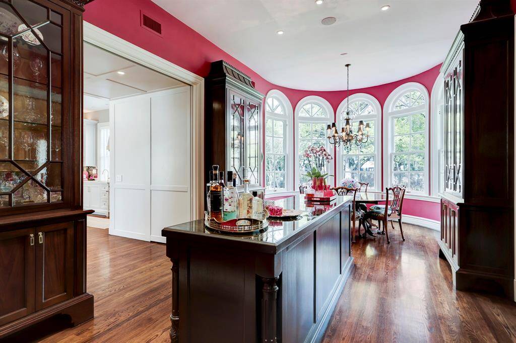The China Room, is centrally located between the Kitchen and Dining Room, and adjacent to the Breakfast area.  The central island with built-ins and wine refrigerator, is a perfect set up for a bar and/or buffet for dinner parties.  Such a creative use of space, yet very elegant for entertaining.