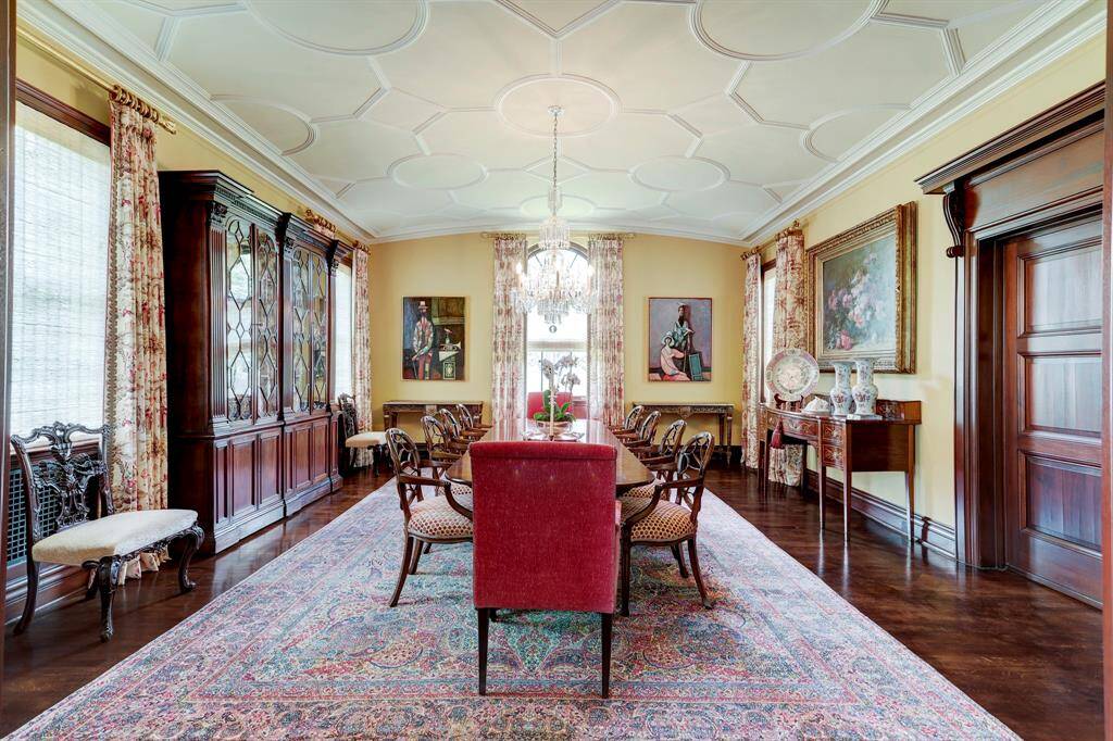Formal Dining Room with restored decorative ceiling, hardwoods and beautiful wood paneled pocket doors can be closed for intimate dinner parties.