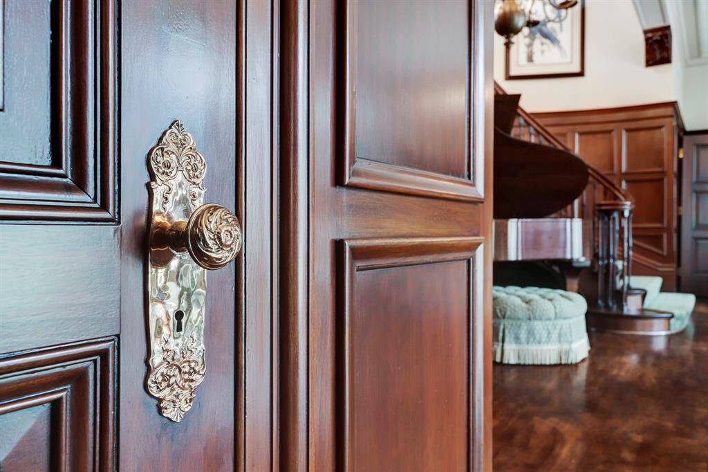 It's all in the details.  The exquisite door and window hardware restored through out the home.  Home was originally designed for hardware magnate F.A. Heitman, dealers in iron and steel and owner of Houston’s first hardware store. Such a lustrous look against the rich wood paneled walls. The current owner oversaw the complete restoration of the original door and window hardware.