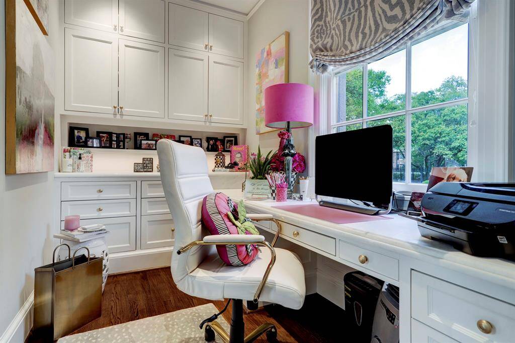 Downstairs office with built in desk and multiple drawers and cabinets.  Excellent views of expansive grounds.