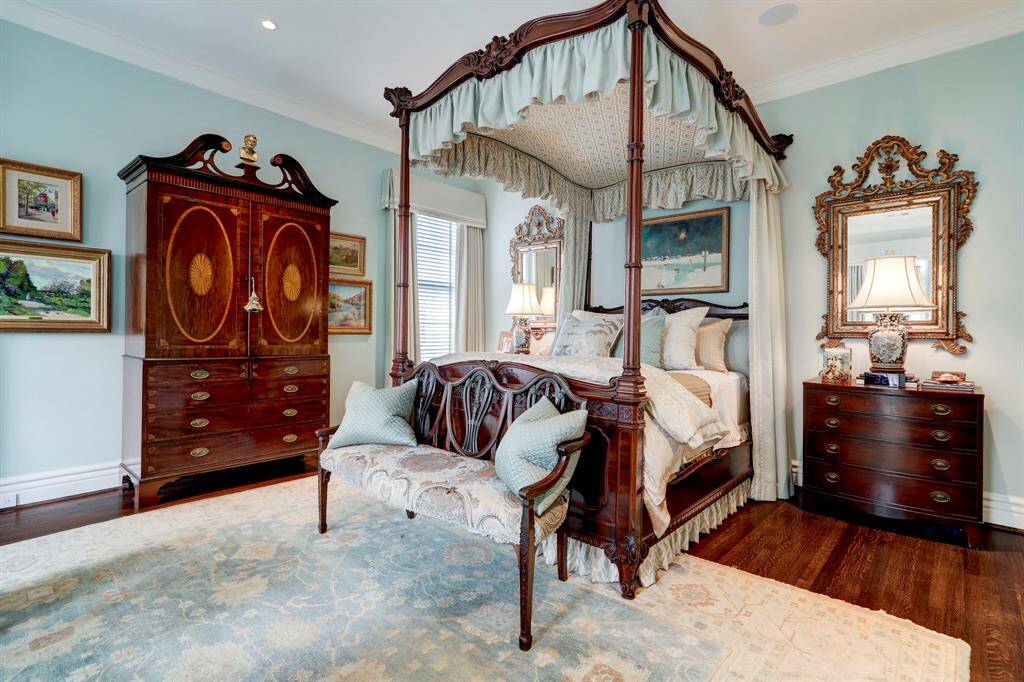 Luxurious primary suite with soothing colors and hardwood floors.  Spacious yet cozy.