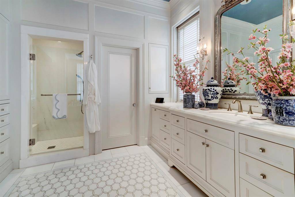 Another view of bath with glass front shower and door to water closet.