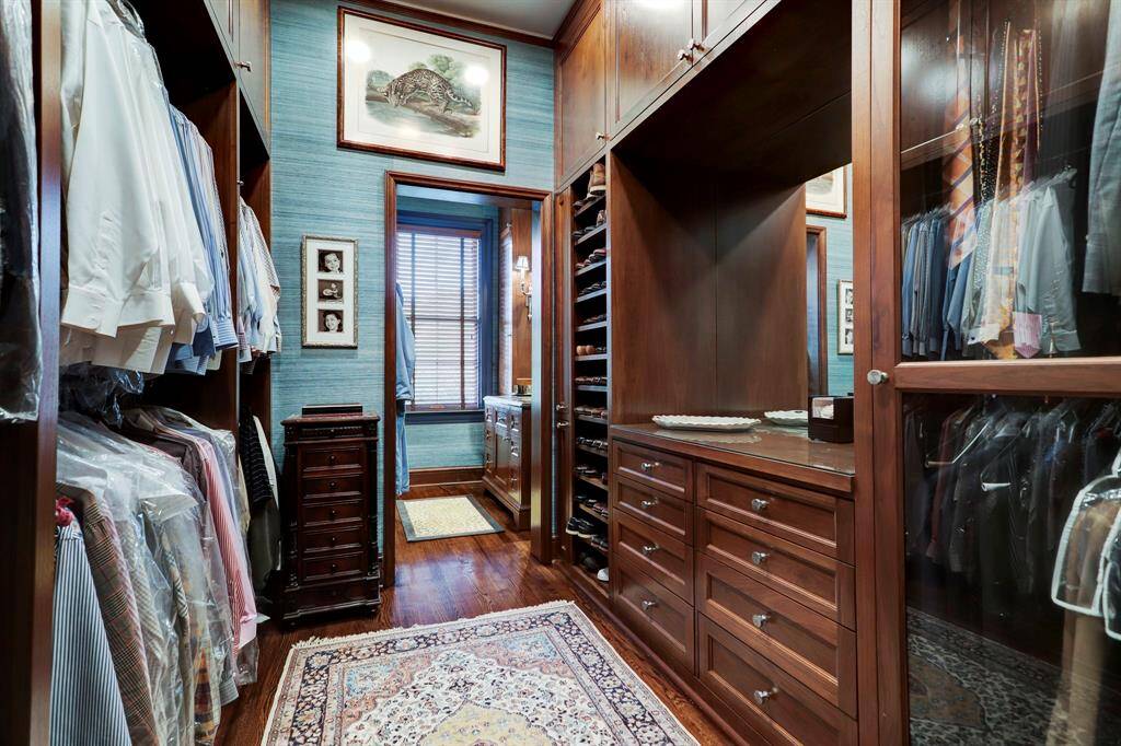 Primary Closet/Dressing Room #2 with multiple built-ins and hardwood floors.