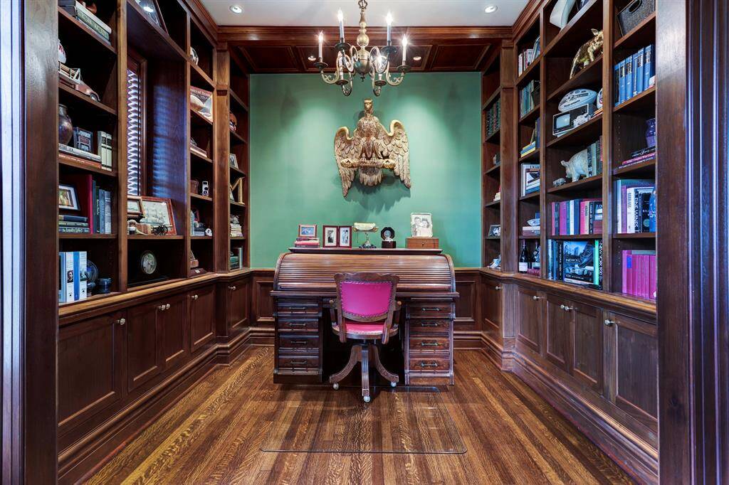 Regal wood paneled library with hardwood floors