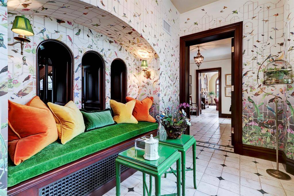 The vibrant Conservatory with covered walls (Sahco "Pardiso") is located between the rear entry hall and the formal powder room.  A light filled nook to read a book, rest or have some cocktails.