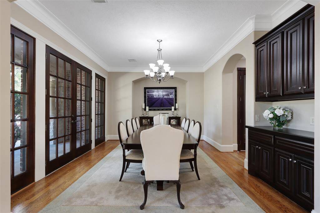 Spacious dining room with French doors that open to the front porch and connect to the wine cellar.