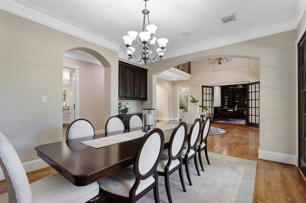 Spacious dining room with French doors that open to the front porch and connect to the wine cellar.