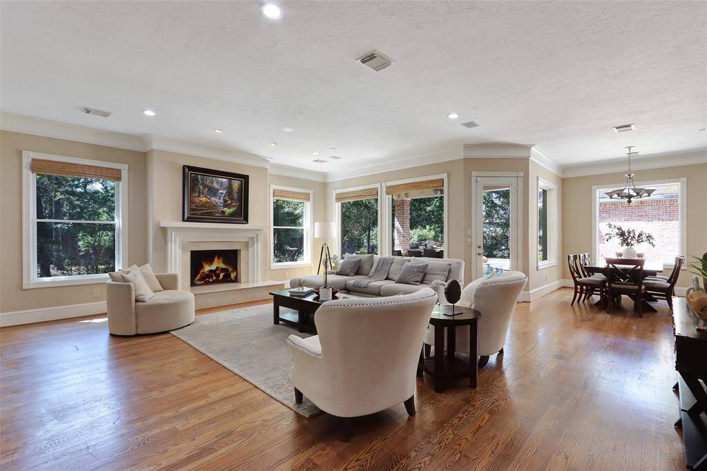 expansive living room with  great view of the back yards and pool area.