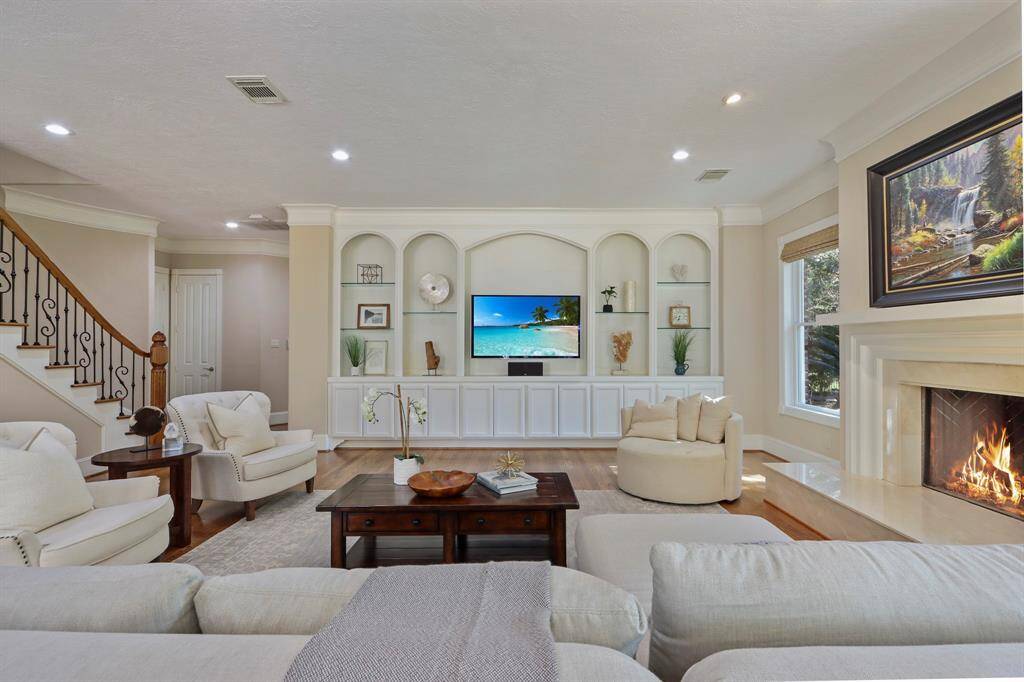 expansive living room with  great view of the back yards and pool area.