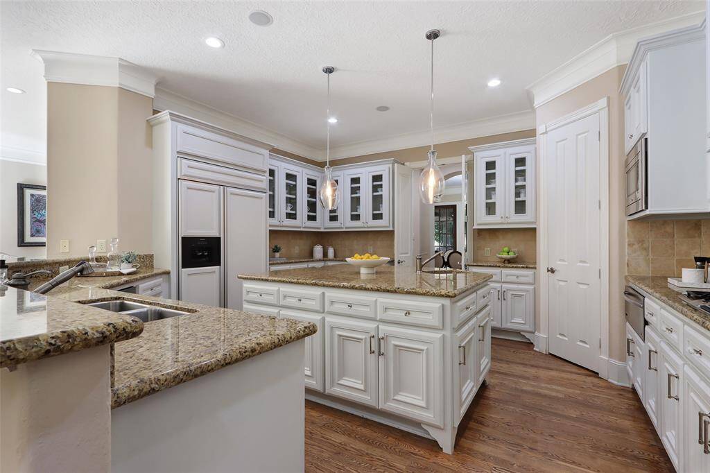 Spacious kitchen with island and breakfast bar.