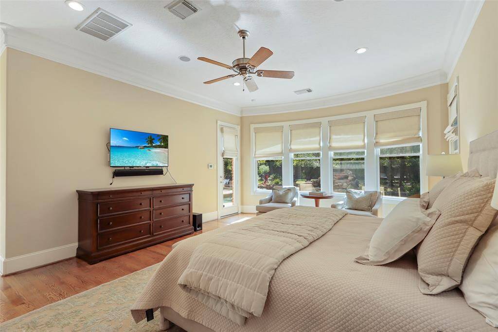 Primary bedroom with view and door to the pool and backyard.