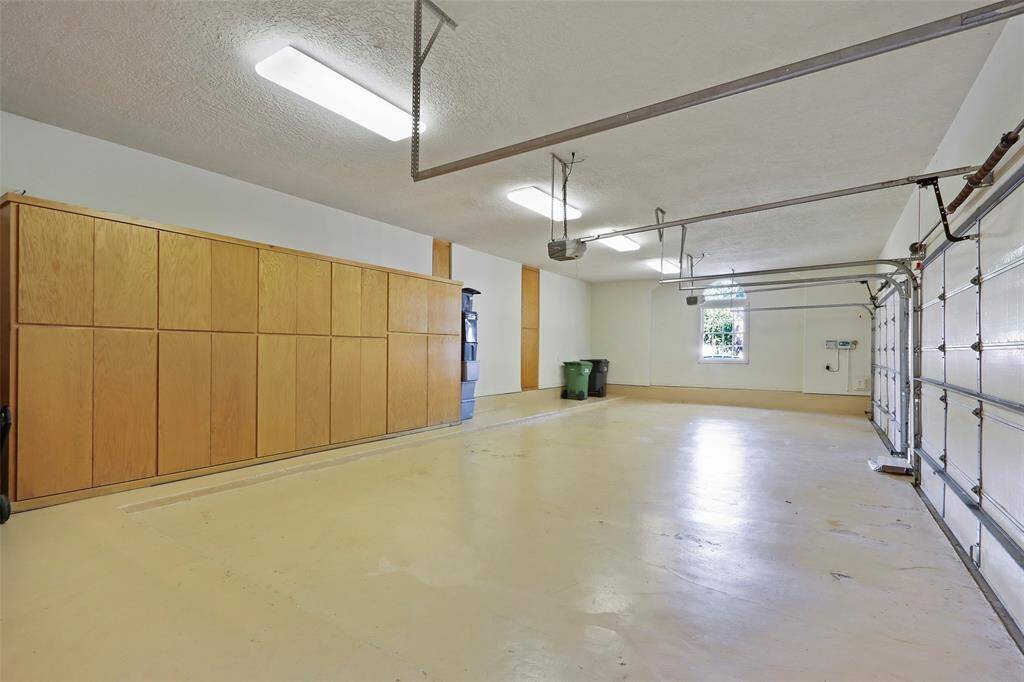 Four car garage with lots of storage and work area