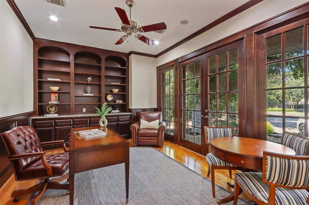 Beautiful office/study with French doors that open to the front porch and built in bookshelf.