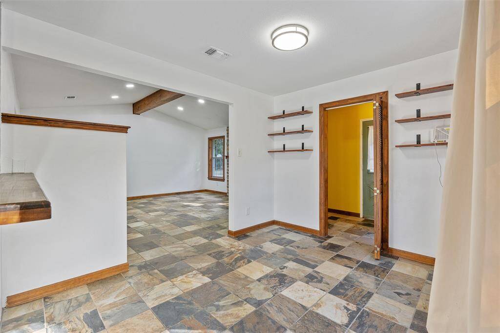 Here is a look at the breakfast area with a peek into the living room and the utility room.