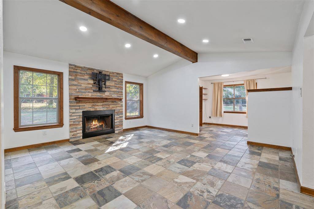 Here is another view of the space, notice the recessed lighting, big windows and mantle above the fireplace. Virtual Fire in fireplace