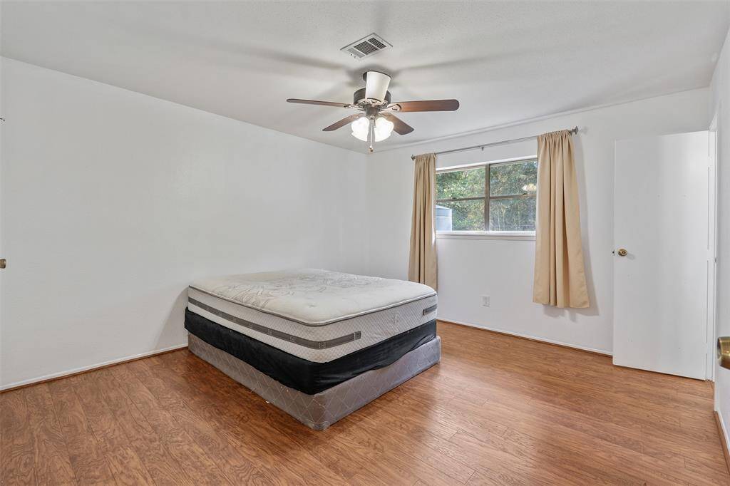 Primary bedroom, see the last picture for approximate room sizes and floorplan.  Ceiling fan to keep cool.