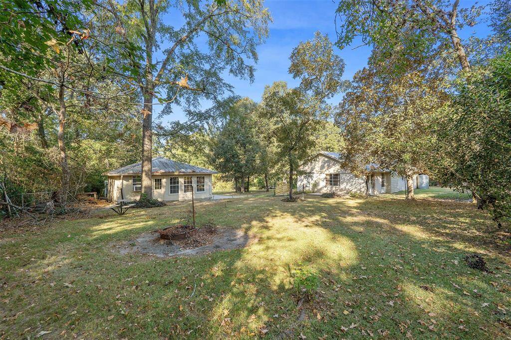 This view shows the home and the detached garage along with the beautiful lot which is 0.99 acres.