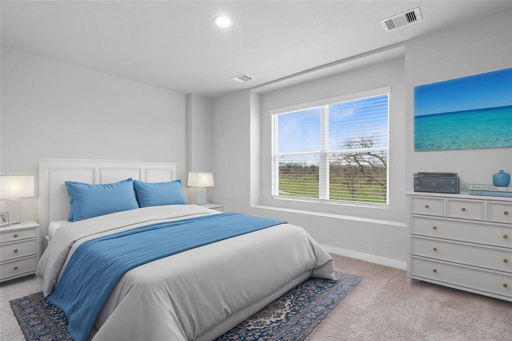 This secondary bedroom features custom paint, plush carpet, and a large window with privacy blinds!