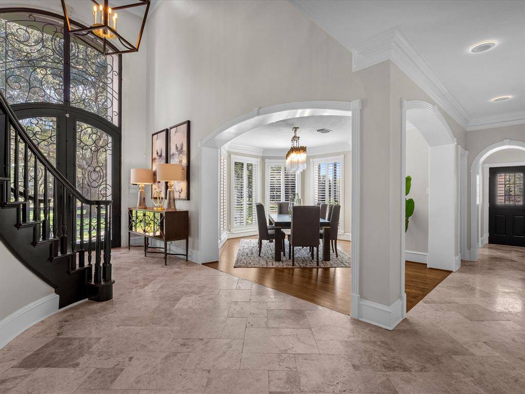 Elegant entryway leads to a sophisticated formal dining room, perfect for hosting memorable gatherings.