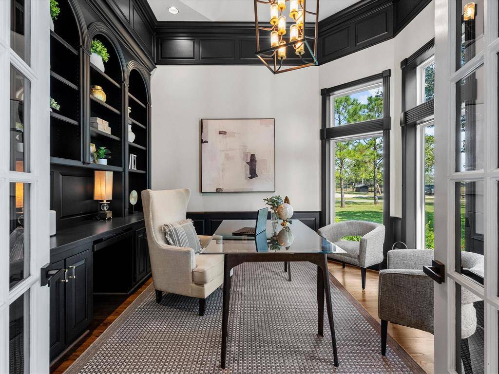 Elegant Home Office with Custom Bookshelves and Ample Natural Light