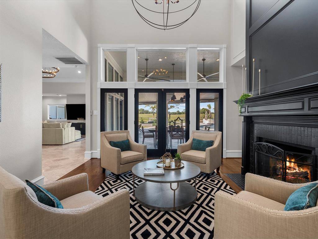 Elegant living space with a cozy fireplace and captivating outdoor views.
