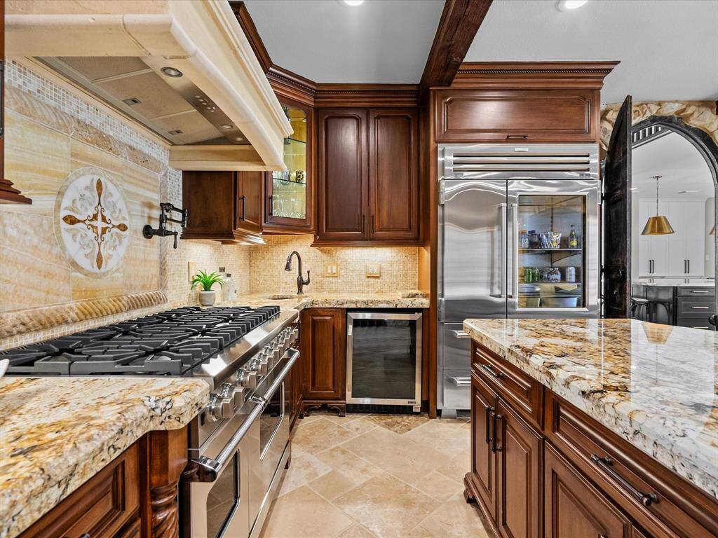 Entertain with ease in this elegant kitchen, seamlessly integrated into a sophisticated wine room—ideal for the discerning host.