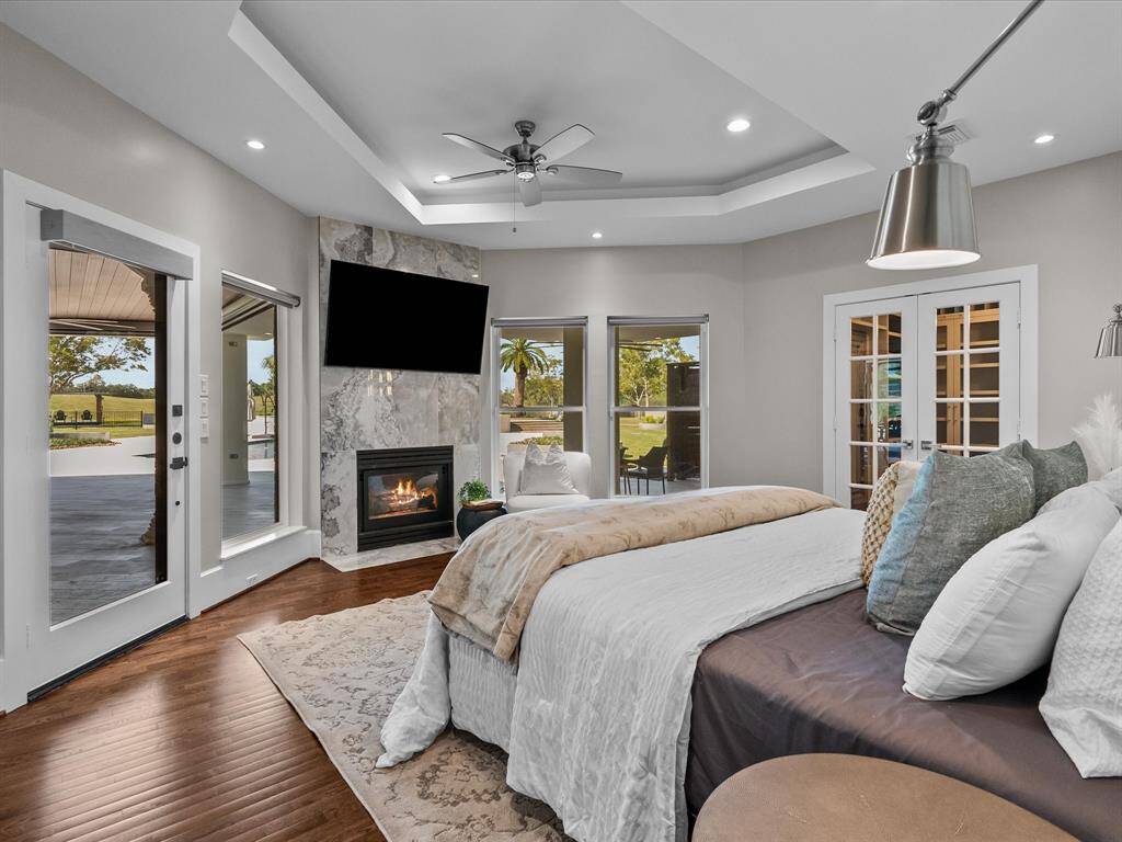 Serene primary suite with elegant fireplace, and outdoor access.