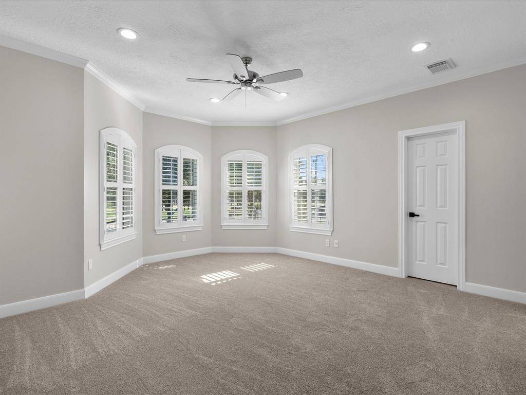 Spacious upper-level bedroom with abundant natural light.