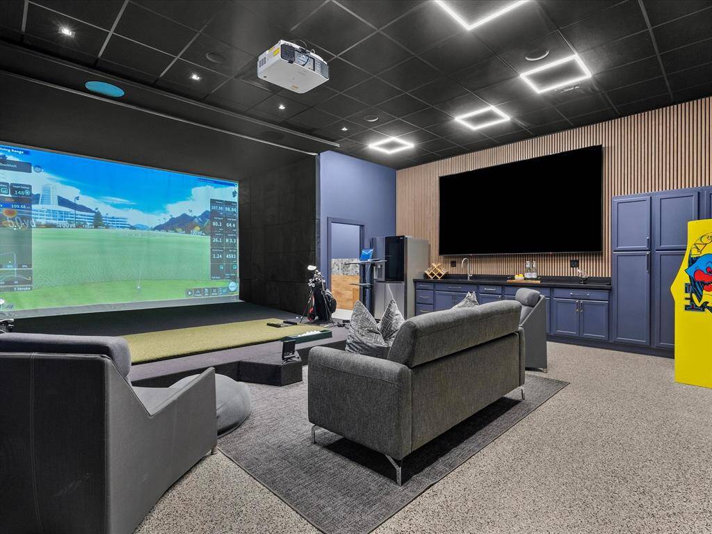 Entertain in style with this ultimate entertainment space, featuring a quad-screen display, integrated storage solutions, a convenient refreshment center with a refrigerator, and a private bathroom.