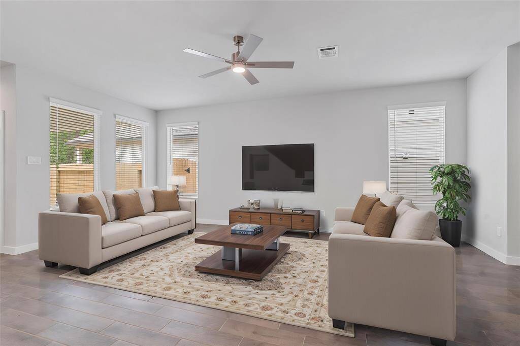 Gather the family and guests together in your lovely family room! Featuring high ceilings with ceiling fan, custom paint, gorgeous wood look floors and large windows that provide plenty of natural lighting throughout the day.