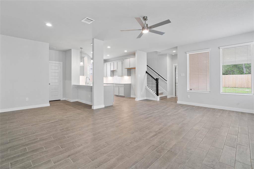 View of the open concept family, dining, kitchen, and staircase that leads to the second floor!