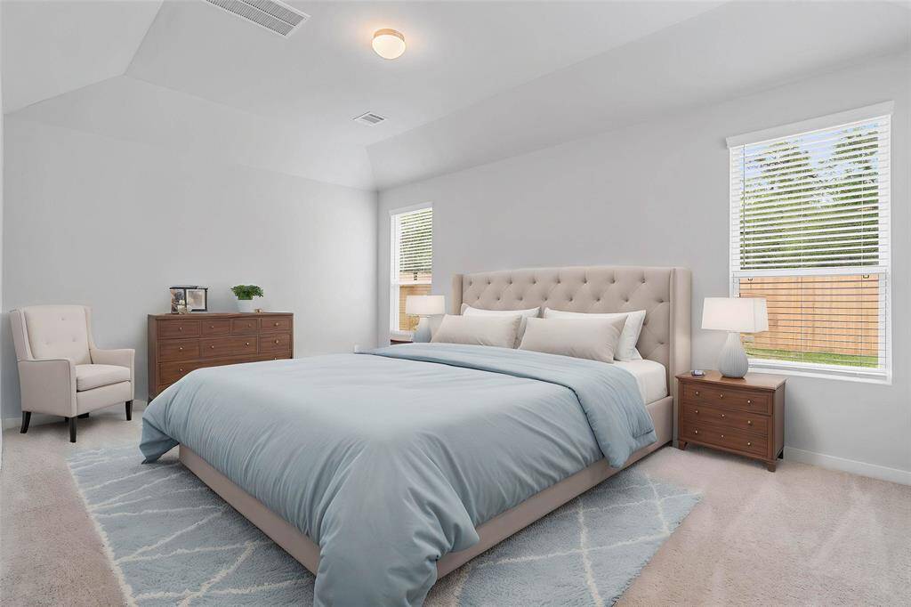 Come and unwind after a long day in this magnificent primary suite! This spacious room features plush carpet, warm paint, high ceilings, and large windows with privacy blinds!