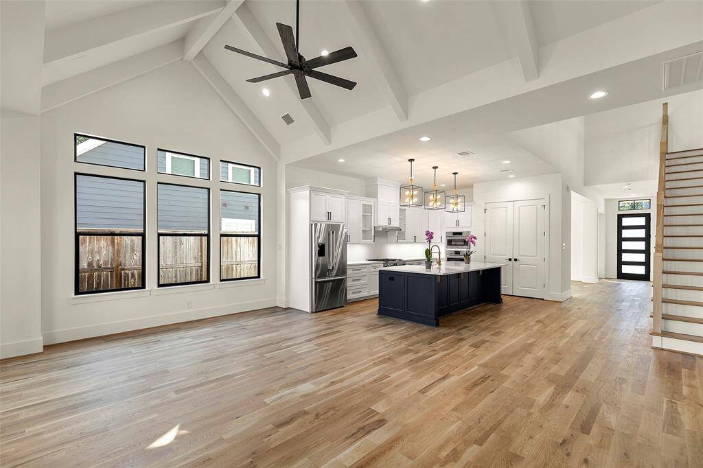 standing at the back of the great room, you look to the spacious cooks  kitchen with its center island, premium cabinetry, dual ovens, professional 6 burner range, new french door refrigerator