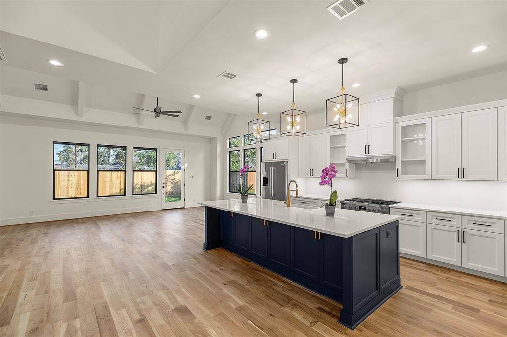 a closer look at the oversized center island, quartz counters, and premium appliances