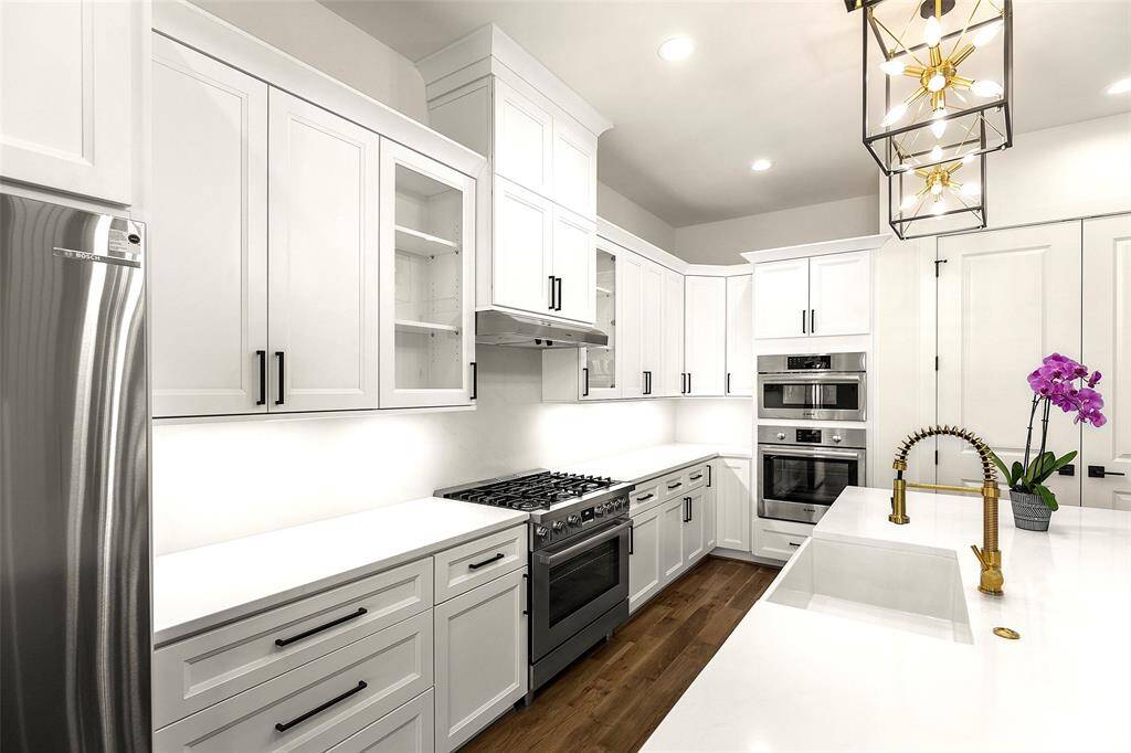 looking to the wood paneled cabinetry, tasteful modern styling, professional appliances(including 6 burner prof range and Bosch)