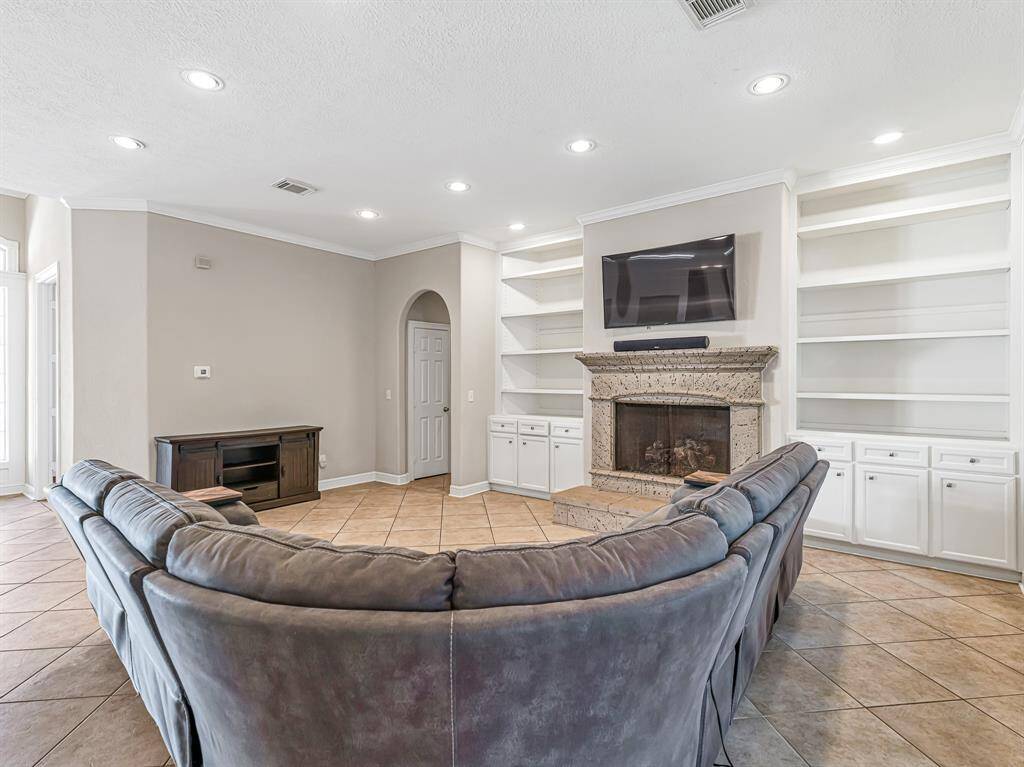 Recessed lighting, crown molding and tile flooring